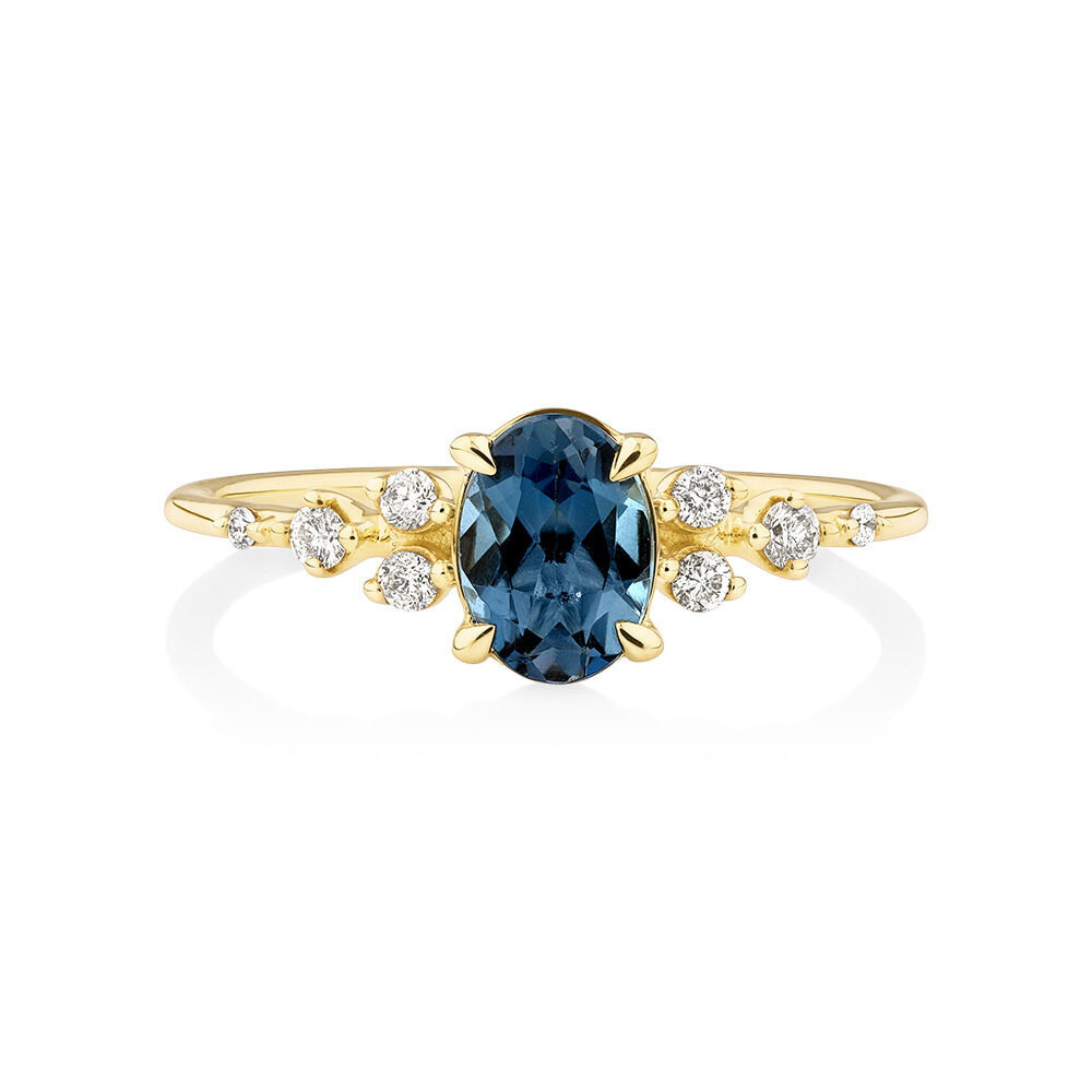Ring with Blue Topaz and 0.12 Carat TW of Diamonds in 10kt Yellow Gold